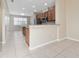 Well-lit kitchen with granite countertops, stainless steel appliances, and an island with wooden accents, set against tile flooring at 8612 Brookvale Dr, Windermere, FL 34786
