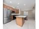 Open kitchen features granite countertops, stainless steel appliances, and a center island, with tile flooring throughout at 8612 Brookvale Dr, Windermere, FL 34786