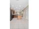 Well-lit kitchen with granite countertops, stainless steel appliances, and an island with wooden accents, set against tile flooring at 8612 Brookvale Dr, Windermere, FL 34786