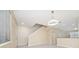 Bright living area featuring neutral walls, tile flooring, and an open staircase, with easy access to the kitchen at 8612 Brookvale Dr, Windermere, FL 34786