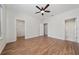 Spacious main bedroom with wood floors and ensuite bathroom with glass shower at 8612 Brookvale Dr, Windermere, FL 34786