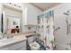 Full bathroom featuring a shower with a beach-themed shower curtain, a vanity, and a toilet at 8923 Legacy Ct # 19-102, Kissimmee, FL 34747
