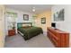 Bedroom featuring a window, ceiling fan, carpet flooring, a dresser, and a bedside table at 8923 Legacy Ct # 19-102, Kissimmee, FL 34747