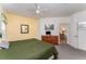 Bedroom with ceiling fan featuring a carpet and views to an adjacent living area at 8923 Legacy Ct # 19-102, Kissimmee, FL 34747