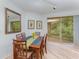 Bright dining room featuring a wood table, seating for six, and sliding glass doors to a balcony at 8923 Legacy Ct # 19-102, Kissimmee, FL 34747