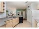 Functional kitchen with stainless steel sink, white appliances, light wood cabinets and a dishwasher at 8923 Legacy Ct # 19-102, Kissimmee, FL 34747