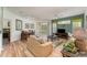 Comfortable living room with hardwood flooring, furniture, and a sliding door that opens onto a screened lanai at 8923 Legacy Ct # 19-102, Kissimmee, FL 34747