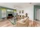 Cozy living room featuring couches, a ceiling fan, hardwood floors, and bright natural light at 8923 Legacy Ct # 19-102, Kissimmee, FL 34747