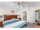 Spacious bedroom featuring a ceiling fan, carpet flooring, and an attached bathroom and walk-in closet at 8923 Legacy Ct # 19-102, Kissimmee, FL 34747