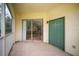 The screened patio has a sliding glass door leading to the home's interior and an additional door to a hallway at 8923 Legacy Ct # 19-102, Kissimmee, FL 34747