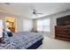 Serene bedroom with a ceiling fan, carpet flooring, and a view into the en-suite bathroom at 8971 Candy Palm Rd, Kissimmee, FL 34747