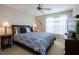 Inviting bedroom featuring carpet floors, a ceiling fan, and a large window with blinds at 8971 Candy Palm Rd, Kissimmee, FL 34747