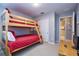 Comfortable bedroom with a wooden bunk bed, carpeted floors, and a closet with sliding doors at 8971 Candy Palm Rd, Kissimmee, FL 34747