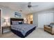 Comfortable bedroom with carpet floors, ceiling fan, closet, and an en-suite bathroom at 8971 Candy Palm Rd, Kissimmee, FL 34747