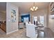 Stylish dining area with modern furnishings, open to the living room, and ample natural light at 8971 Candy Palm Rd, Kissimmee, FL 34747