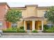 Inviting exterior of a yellow townhome with a red tile roof and well-maintained landscaping at 8971 Candy Palm Rd, Kissimmee, FL 34747