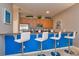 Bright kitchen featuring a breakfast bar with seating for four and wood cabinetry at 8971 Candy Palm Rd, Kissimmee, FL 34747