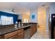 Modern kitchen with granite countertops and stainless-steel appliances, overlooking the dining area at 8971 Candy Palm Rd, Kissimmee, FL 34747
