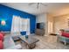 Open-concept living area showcasing tile floors, modern decor, and access to the dining area at 8971 Candy Palm Rd, Kissimmee, FL 34747