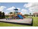 Community playground with modern play equipment and a cushioned ground, designed for children to enjoy active outdoor play at 8971 Candy Palm Rd, Kissimmee, FL 34747