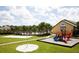 View of a well-equipped playground, a volleyball court and a large grassy area, offering a variety of recreational activities at 8971 Candy Palm Rd, Kissimmee, FL 34747