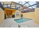 Beautiful pool area with a covered lanai, comfortable seating, and access to the backyard at 8971 Candy Palm Rd, Kissimmee, FL 34747