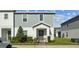 Charming two-story townhouse with a well-manicured front yard and inviting front door at 1171 Sand Torch Cir, Davenport, FL 33837