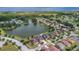 Panoramic aerial view showcases a neighborhood surrounding a tranquil lake, offering a picturesque setting at 2784 Corbel Loop, Kissimmee, FL 34746
