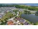 Beautiful aerial view of a residential community with a large pond, lush green spaces, and waterfront homes at 2784 Corbel Loop, Kissimmee, FL 34746