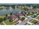 Aerial view of neighborhood with a beautiful lake in the background at 2784 Corbel Loop, Kissimmee, FL 34746