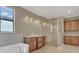 Relaxing bathroom featuring dual vanities, a soaking tub, and a glass-enclosed shower at 2784 Corbel Loop, Kissimmee, FL 34746