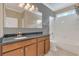 Bathroom featuring a granite-topped vanity, a large mirror and a shower-tub combo at 2784 Corbel Loop, Kissimmee, FL 34746