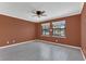 Comfortable bedroom with gray laminate flooring, ceiling fan, and lots of natural light at 2784 Corbel Loop, Kissimmee, FL 34746