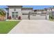 Well-manicured front yard, three-car garage, and neutral paint create inviting curb appeal at 2784 Corbel Loop, Kissimmee, FL 34746