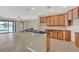 Bright kitchen with breakfast bar, cabinetry, and tiled floors at 2784 Corbel Loop, Kissimmee, FL 34746
