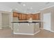Spacious kitchen featuring tiled floors, ample cabinet space, and a convenient breakfast bar at 2784 Corbel Loop, Kissimmee, FL 34746