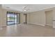 Bright, expansive living room with tile floors and a sliding glass door to a screened in patio at 2784 Corbel Loop, Kissimmee, FL 34746