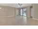 Open-concept living room featuring neutral paint, tile flooring and a sliding glass door to the porch at 2784 Corbel Loop, Kissimmee, FL 34746