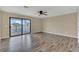 Open living room featuring hardwood flooring, neutral walls and a sliding glass door to the porch at 2784 Corbel Loop, Kissimmee, FL 34746