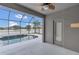Covered patio with a ceiling fan right off the enclosed pool area with a view of the lake at 2784 Corbel Loop, Kissimmee, FL 34746