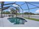 Enclosed pool area with hot tub overlooking a serene lake, perfect for relaxation and outdoor enjoyment at 2784 Corbel Loop, Kissimmee, FL 34746