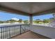 View of the porch overlooking a large lake with beautiful landscaping and community homes at 2784 Corbel Loop, Kissimmee, FL 34746