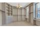 Spacious walk-in closet with custom shelving, drawers and window offering lots of natural light at 2784 Corbel Loop, Kissimmee, FL 34746