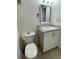 Bright bathroom with tile floors, a toilet, and a vanity featuring white cabinets and hardware at 4745 S Texas Ave # A, Orlando, FL 32839