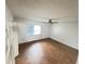 Bedroom with wood-look floors, ceiling fan, closet, and window providing natural light at 4745 S Texas Ave # A, Orlando, FL 32839