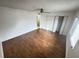 Bedroom with wood-look floors, ceiling fan, closet, and window providing natural light at 4745 S Texas Ave # A, Orlando, FL 32839