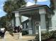 Building entrance showcasing the covered entryway with decorative plants at 4745 S Texas Ave # A, Orlando, FL 32839