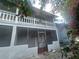 Backside view of the property including a screened-in porch on two levels at 4745 S Texas Ave # A, Orlando, FL 32839