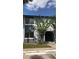 Two-story building with a tree in front of the entrance featuring a stairwell and bright windows at 4745 S Texas Ave # A, Orlando, FL 32839
