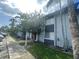 Two-story condo building featuring well-kept landscaping, a sidewalk and palm trees at 4745 S Texas Ave # A, Orlando, FL 32839